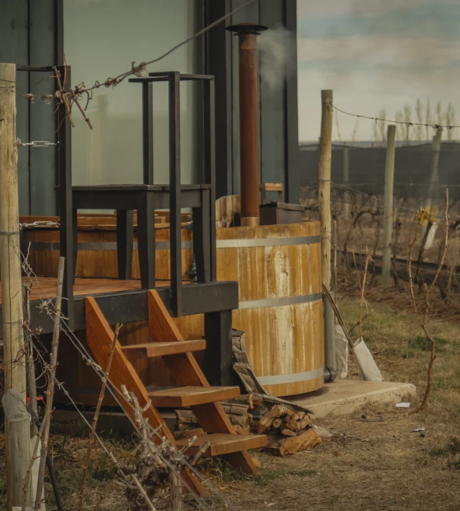 Industrial machine next to wooden barrels and fences with barbed wire